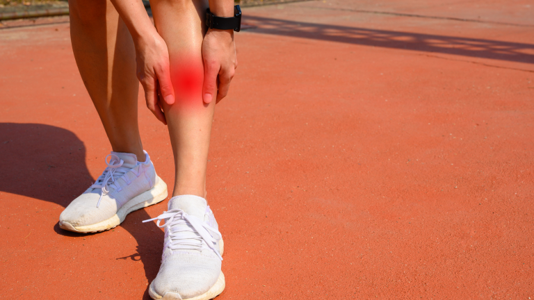 woman experiencing shin splints who needs to go to the chiropractor for dry needling